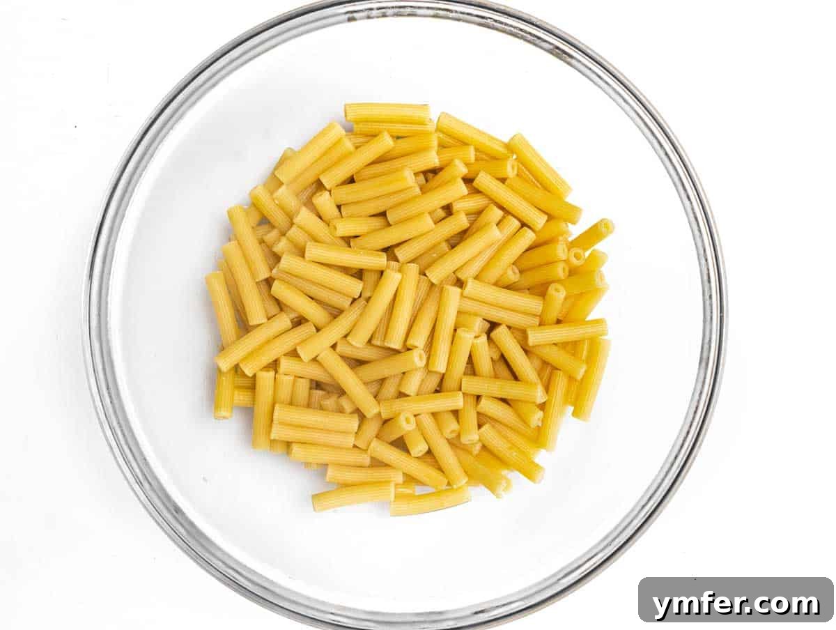 Golden Harvest Pumpkin Pasta 7 Cooked ziti pasta resting in a large mixing bowl, ready for the sauce.