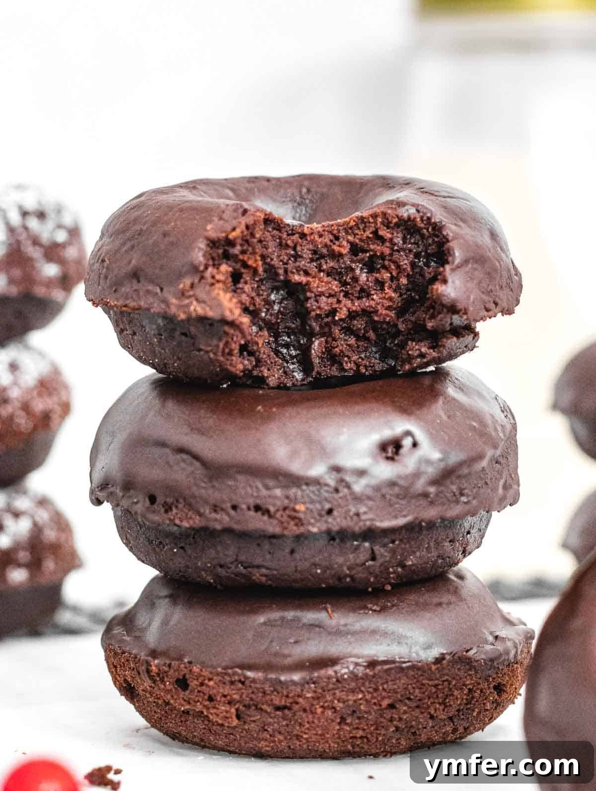 Decadent Chocolate-Coated Doughnuts 2 Chocolate donuts with glaze and bite