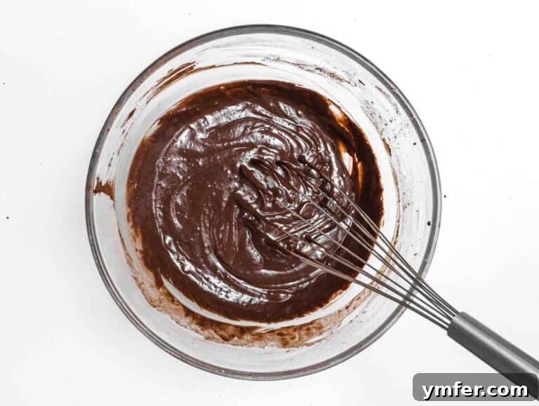Decadent Chocolate-Coated Doughnuts 16 Whisk and chocolate mix in a glass bowl