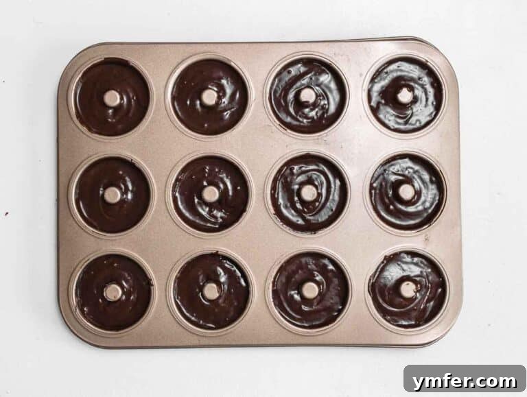 Decadent Chocolate-Coated Doughnuts 17 donut batter in donut cake pan