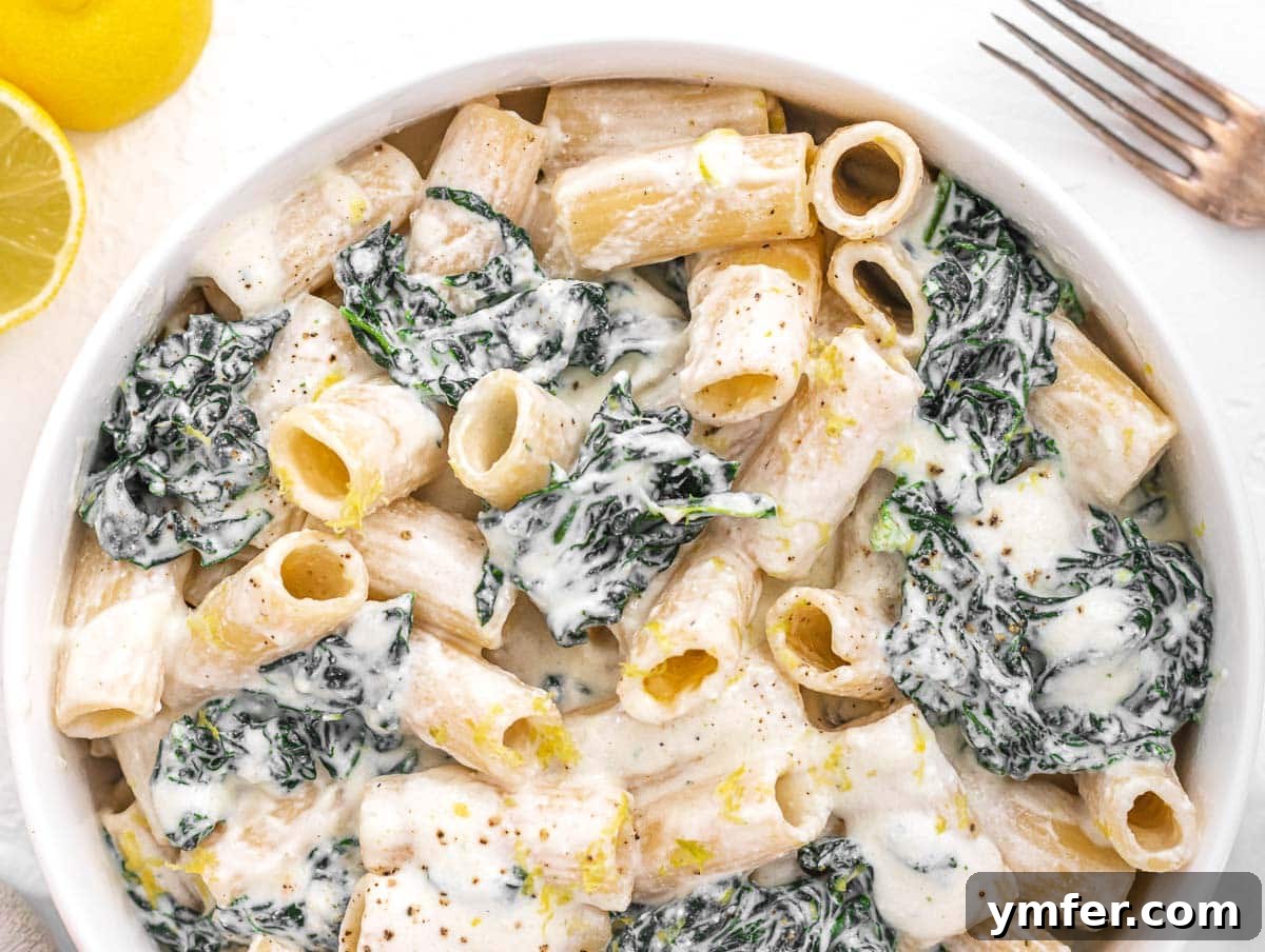 Royal Spire Sweet 12 Creamy Kale Pasta in a bowl with a fork, ready to be eaten
