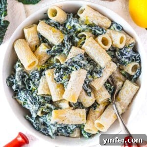 Royal Spire Sweet 14 Kale pasta in a white bowl with lemon on the side