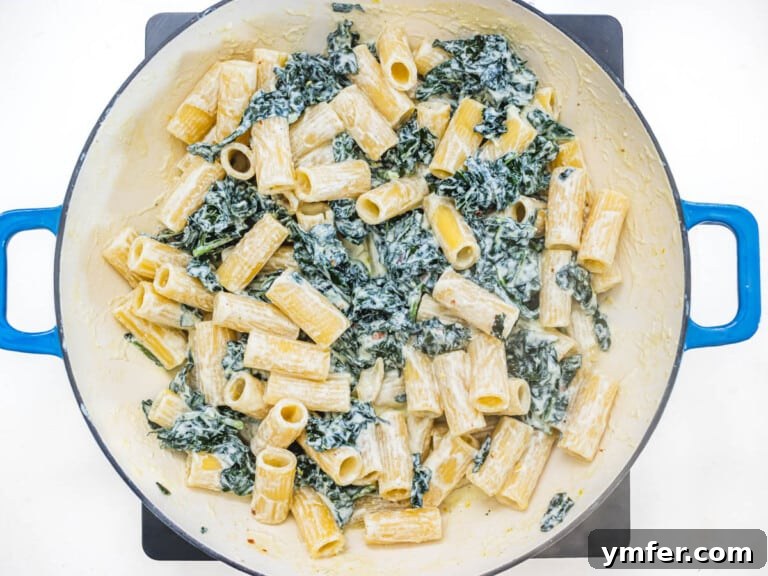 Royal Spire Sweet 19 rigatoni pasta in a skillet with ricotta sauce and kale leaves