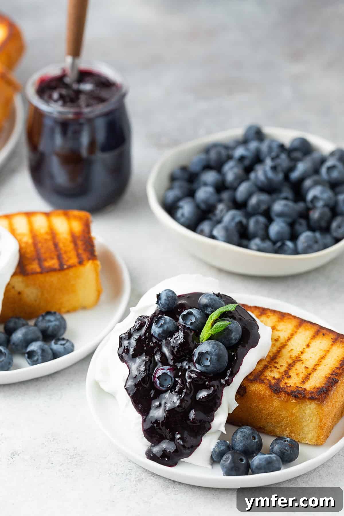 Flame-Kissed Pound Slice 2 Grilled Pound Cake topped with Cool Whip and blueberry compote.