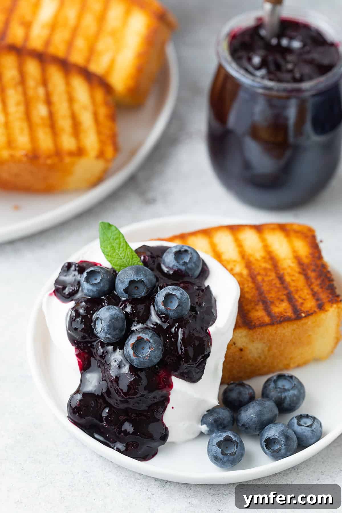 Grilled Pound Cake a la Mode by Nutmeg Nanny Grilled Pound Cake topped with blueberry compote, fresh blueberries and whipped cream.