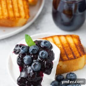Grilled Pound Cake topped with blueberry compote, fresh blueberries and whipped cream.