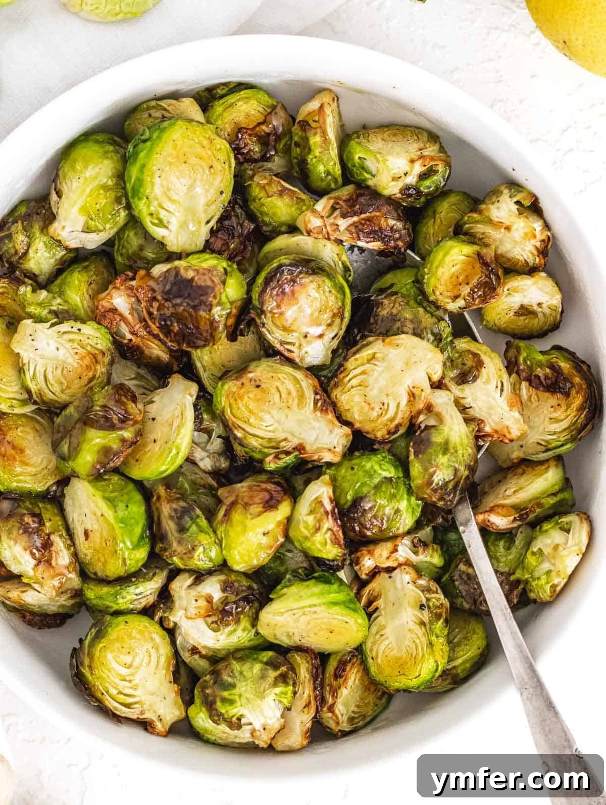 Crispy Air Fryer Brussels Sprouts 2 Air fryer Brussels Sprouts in a bowl with spoon