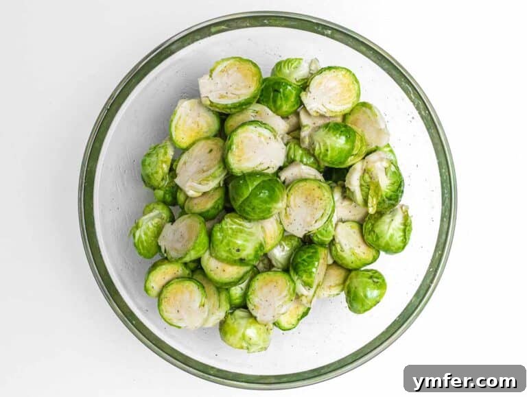 Brussels sprouts and oil in bowl