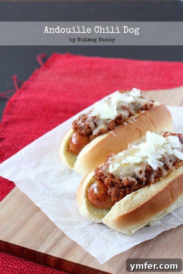 Spicy Andouille Chili Dog with homemade chili, melted cheese, and chopped onions