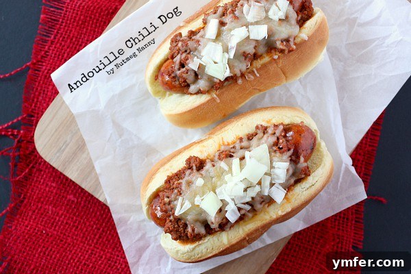 Close-up of a spicy Andouille chili dog topped with rich chili and cheese