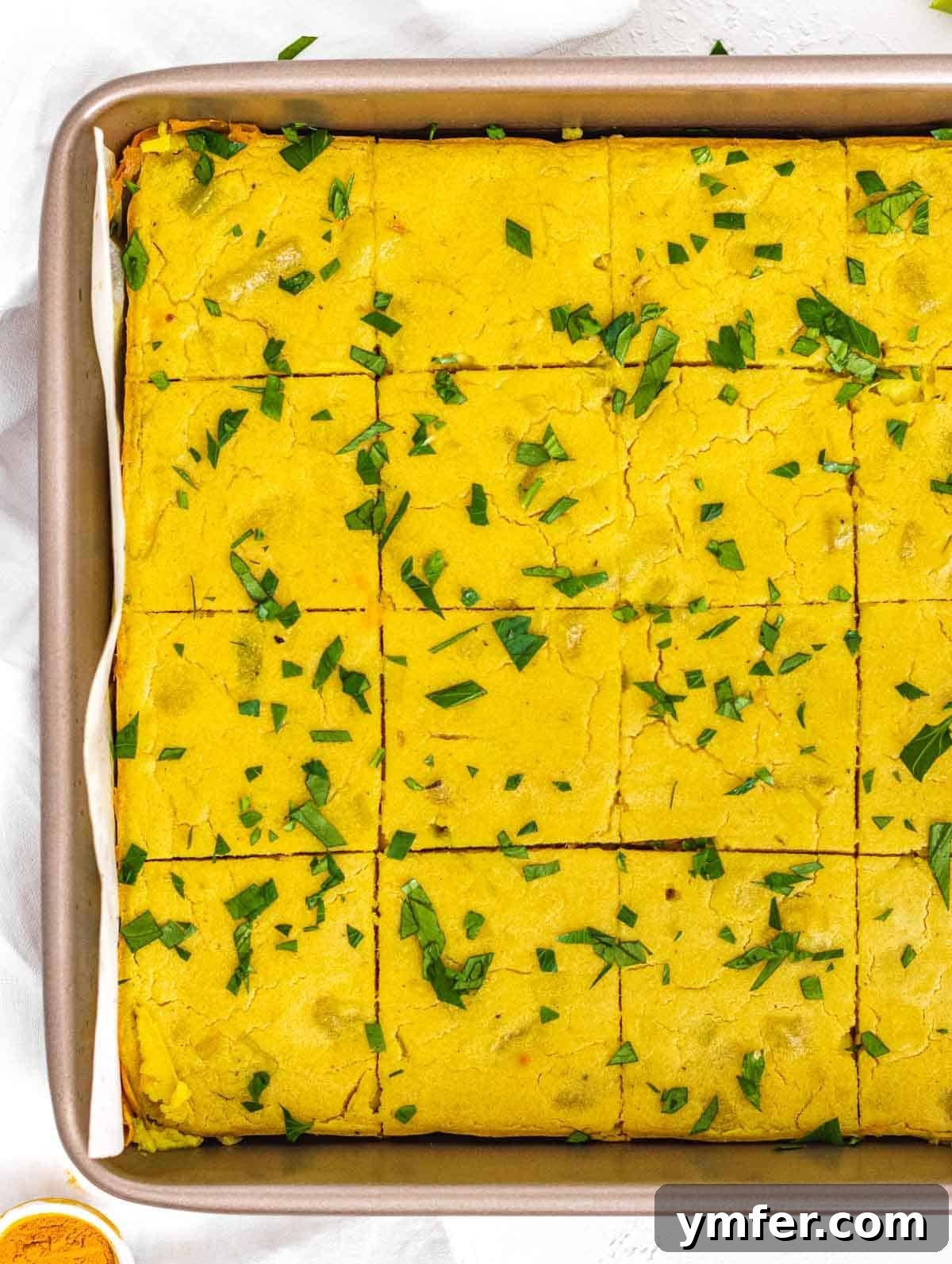 Vegan Potato Frittata 2 Golden-brown vegan potato frittata with leek in a baking tray, ready to be sliced.