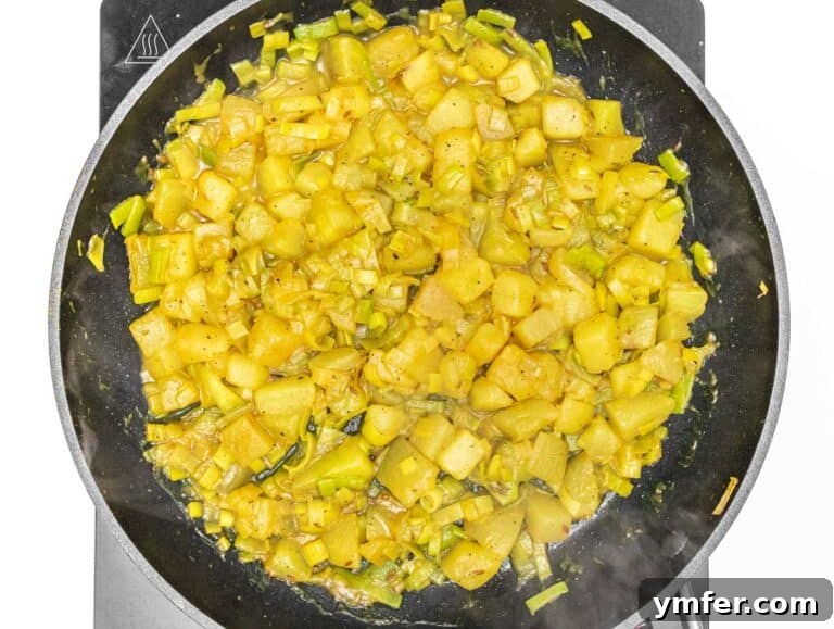 Vegan Potato Frittata 14 fried leek and potato in a pan