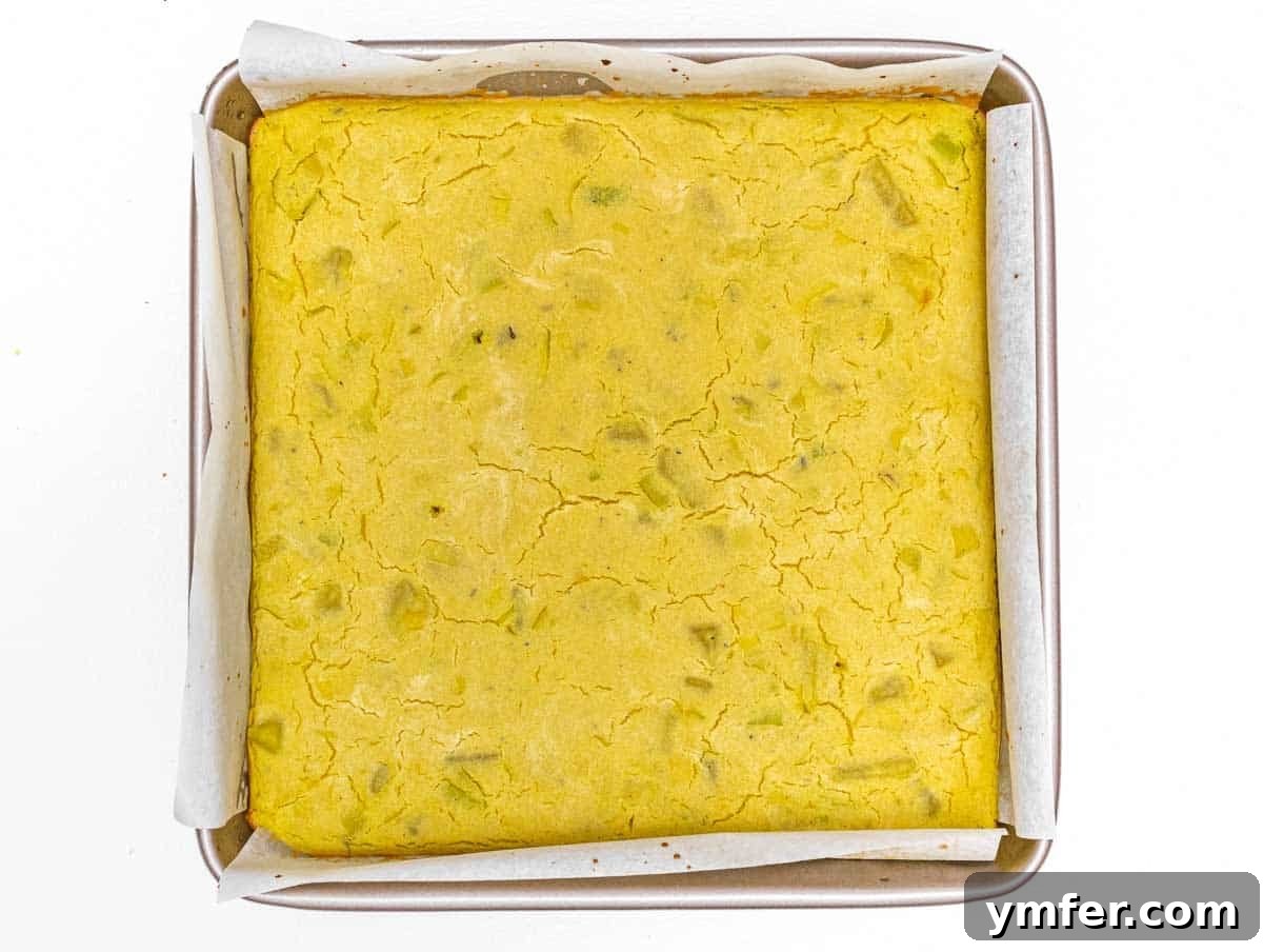 Vegan Potato Frittata 10 Freshly baked vegan potato frittata, golden brown and puffed, cooling in the square baking pan.