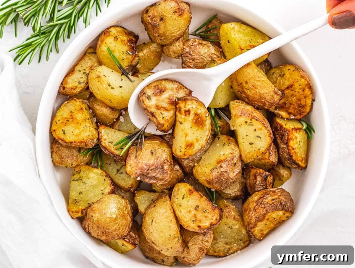 Crispy Air Fryer Potatoes 5 Air fryer potatoes with hand and spoon