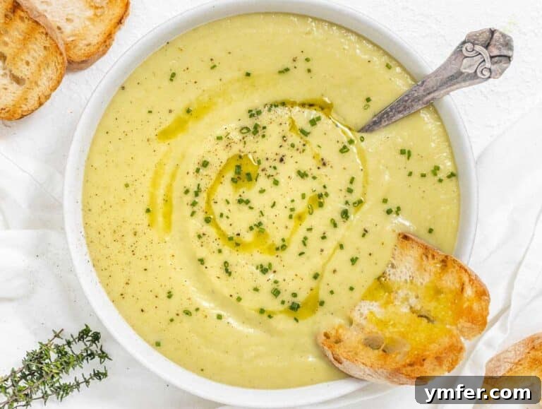 Naturally Creamy Potato Leek Soup with Skyr 12 Step 4 Bowl of potato leek soup garnished with chives and a drizzle of olive oil.