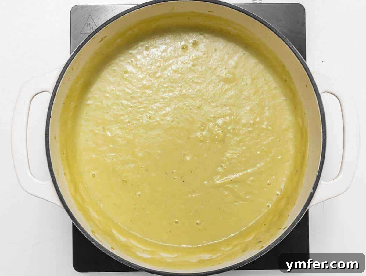 Naturally Creamy Potato Leek Soup with Skyr 6 Step 3 Blending creamy potato leek soup with skyr using an immersion blender.
