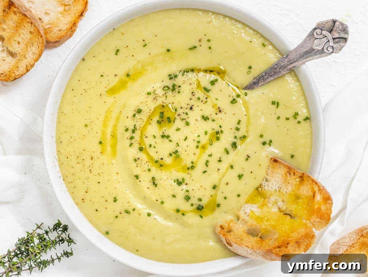 Naturally Creamy Potato Leek Soup with Skyr 7 Step 4 Bowl of potato leek soup garnished with chives and a drizzle of olive oil.