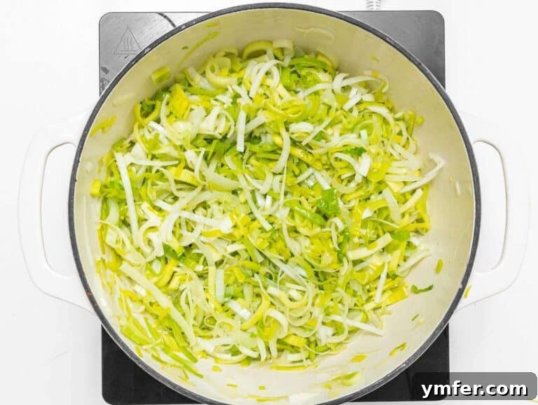 Naturally Creamy Potato Leek Soup with Skyr 9 Step 1 Sliced leeks and onion sautéing in olive oil in a large pot.