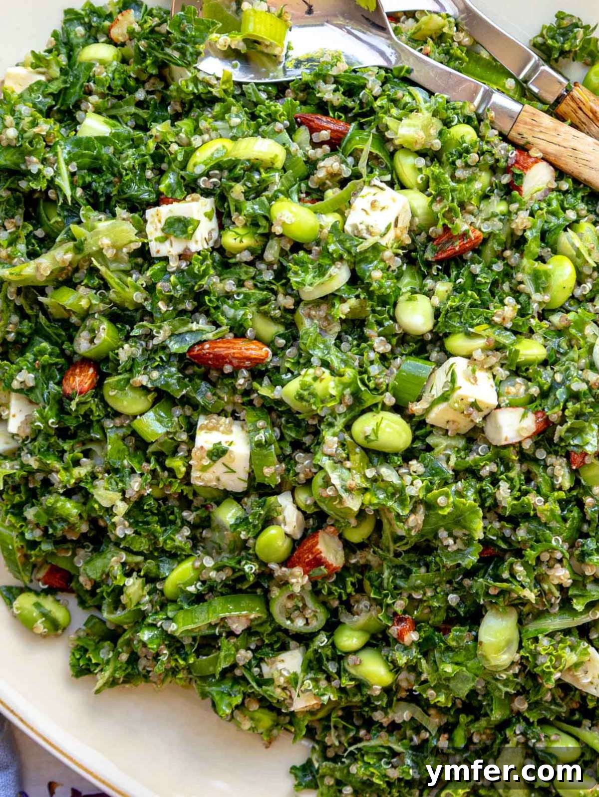 Top-down view of kale quinoa salad served on a large platter, perfect for a healthy plant-based lunch or vegetarian meal prep