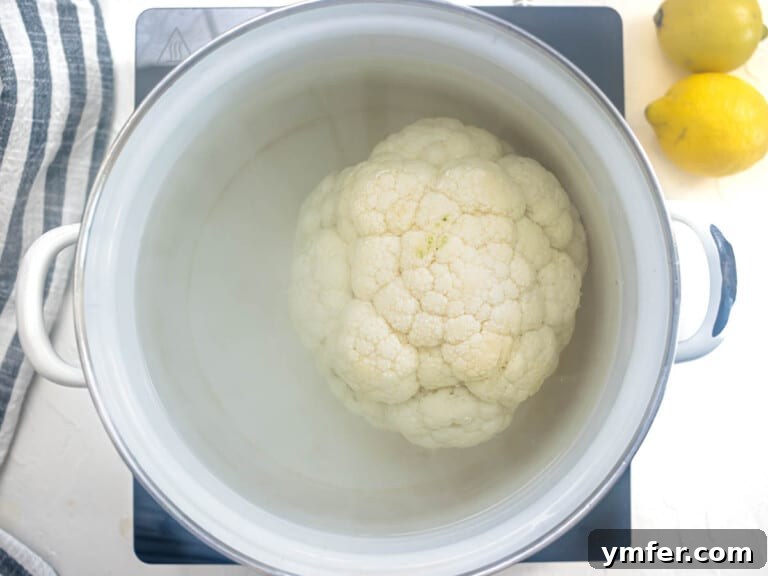Glorious Whole Roasted Cauliflower 15 whole head of cauliflower boiling in a white pot