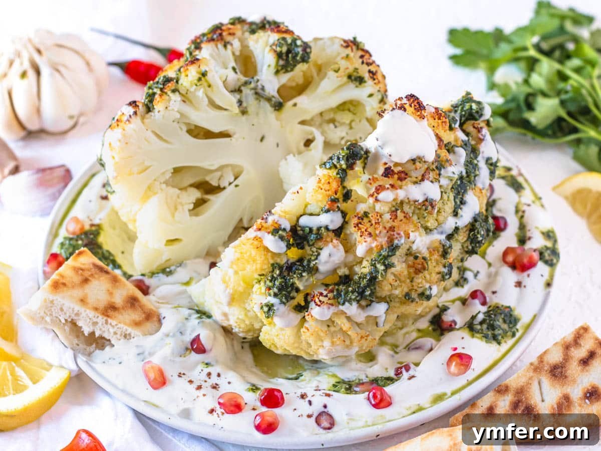 Glorious Whole Roasted Cauliflower 5 Easy whole roasted cauliflower with tahini sauce on a plate