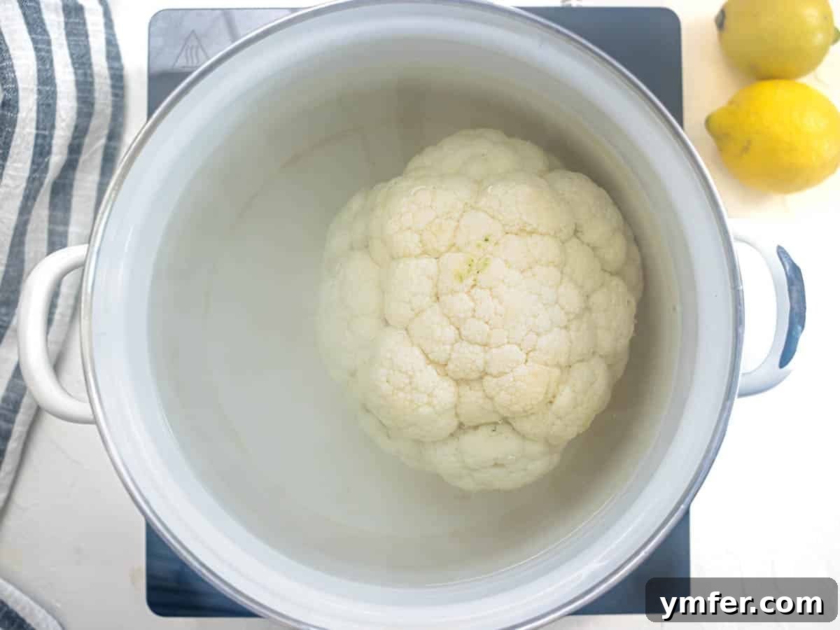Glorious Whole Roasted Cauliflower 7 whole head of cauliflower boiling in a white pot