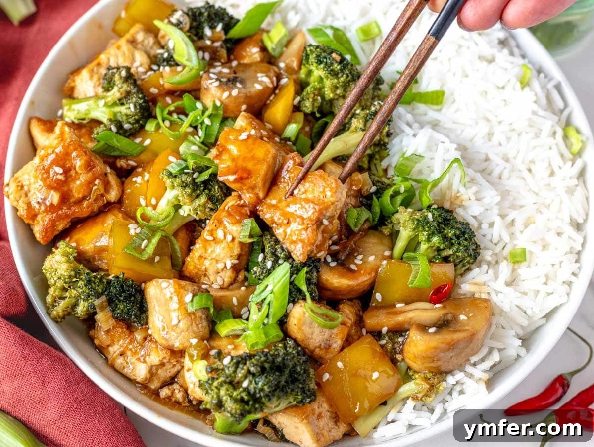 Quick & Delicious: 20 Easy Broccoli Recipes 7 A vibrant tofu stir-fry served over fluffy rice, featuring crispy tofu and fresh broccoli.