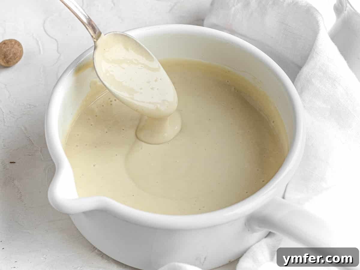 Luscious Vegan Cream Sauce 7 A close-up of the finished vegan white sauce in a white pot, displaying its rich, smooth texture.