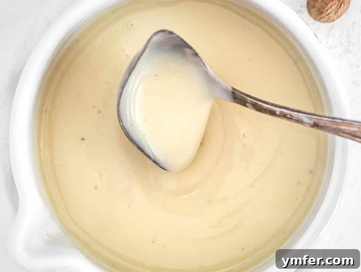 Luscious Vegan Cream Sauce 8 Vegan béchamel sauce cooling down in a saucepan, showing techniques to prevent skin formation.
