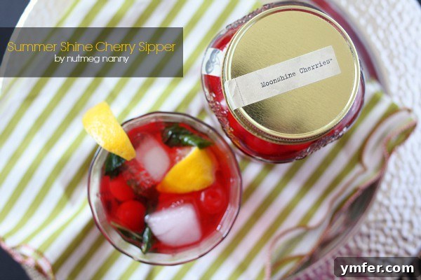 Sun-Kissed Cherry Moonshine 2 Refreshing Cherry Moonshine Summer Sipper with mint and lemon in a clear glass, perfect for sunny days.