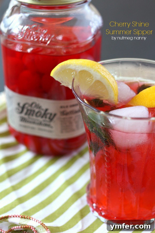 Sun-Kissed Cherry Moonshine 4 A beautifully garnished Cherry Moonshine Summer Sipper with mint, lemon, and cherries, ready to be enjoyed.