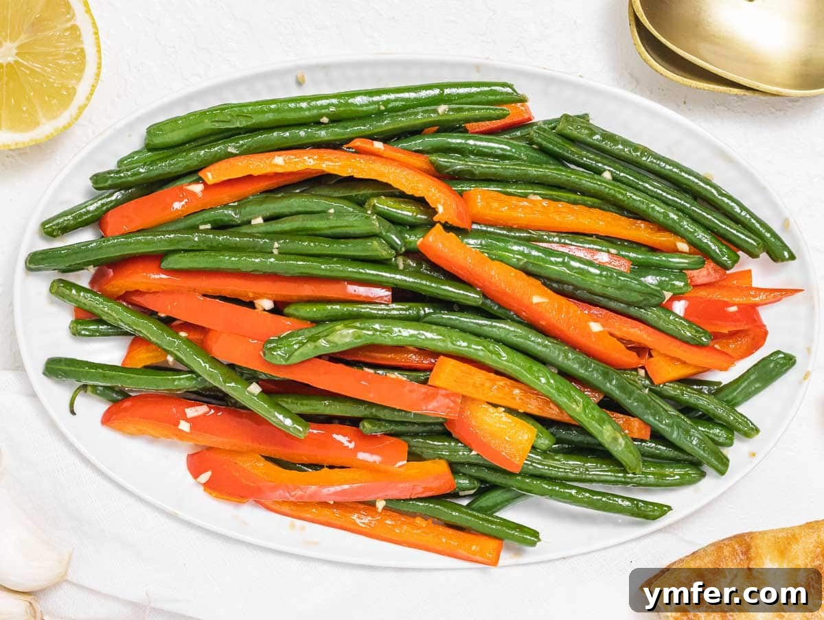Flavorful Sautéed Green Beans 14 Sautéed green beans mixed with vibrant red bell pepper strips, cooked to perfection in a skillet