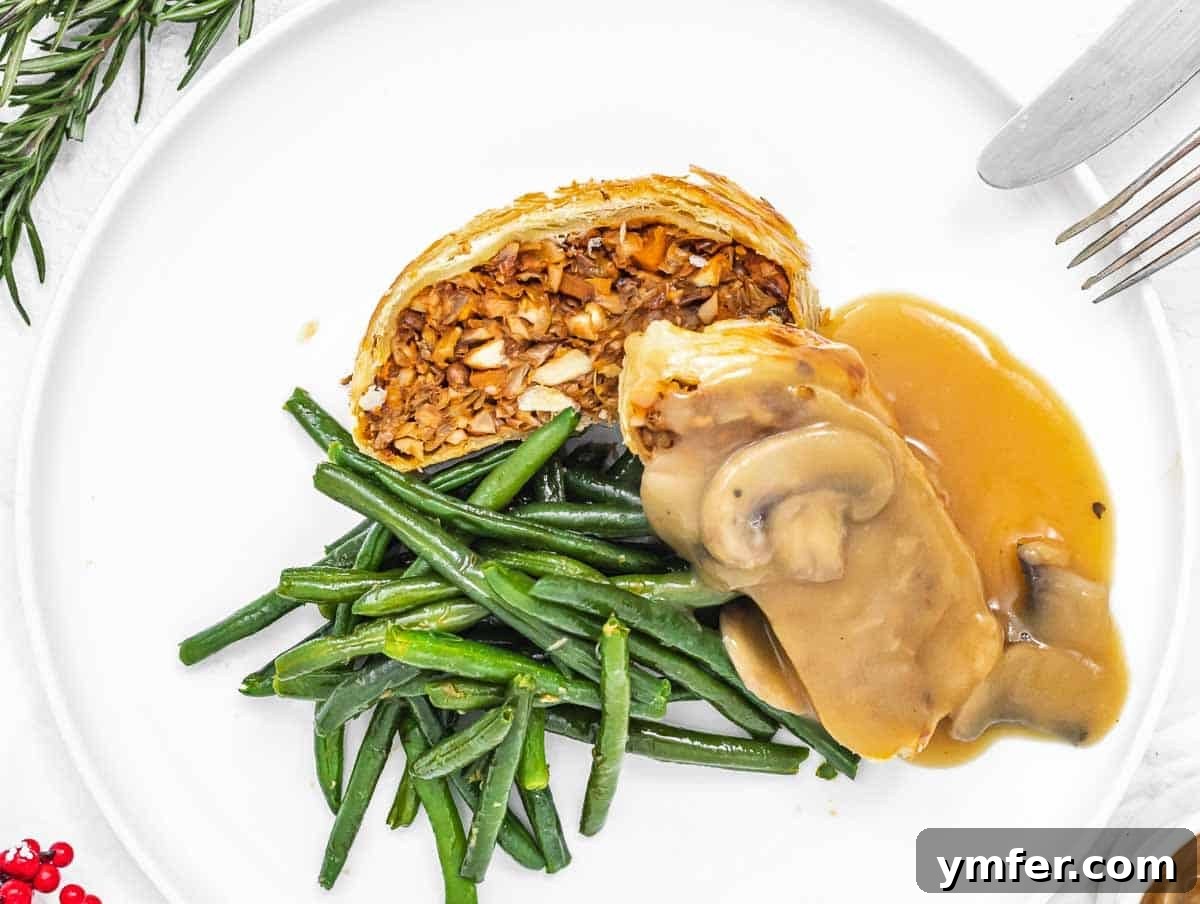 Flavorful Sautéed Green Beans 15 A beautifully presented Lentil Wellington served with a generous portion of mushroom gravy and a side of vibrant sautéed green beans, ideal for a special meal