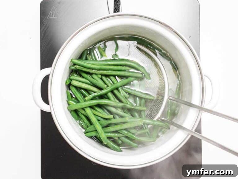 green beans boiling in a white pot