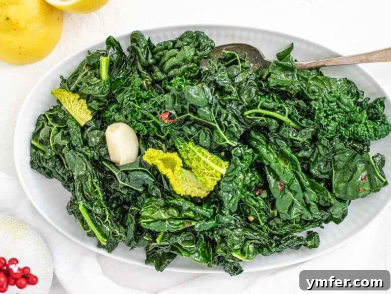 Cooked sautéed kale on a white platter, ready to be served