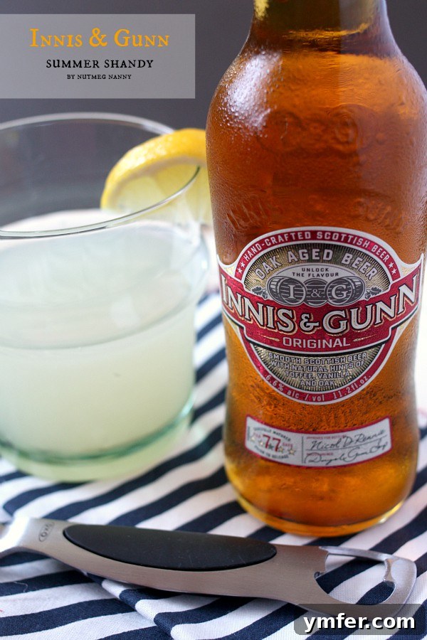 Innis Gunn Sunshine Shandy 4 Three glasses of Innis & Gunn summer shandy, garnished with lemon slices, displayed on a wooden surface, ready for enjoyment.