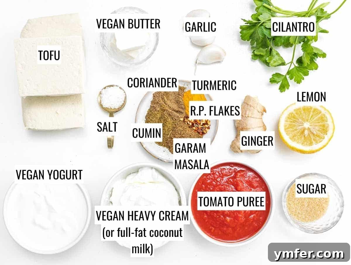 Velvety Vegan Butter Chicken 4 A vibrant selection of ingredients for vegan butter chicken, including fresh spices, tofu, tomatoes, and vegan cream.