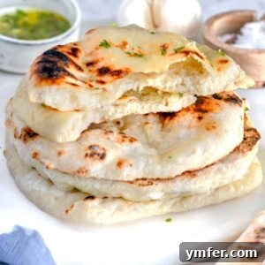 Naan bread stacked on a marble plate