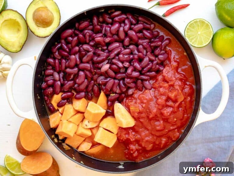 kidney beans, sweet potatoes, and diced tomatoes added to the pot
