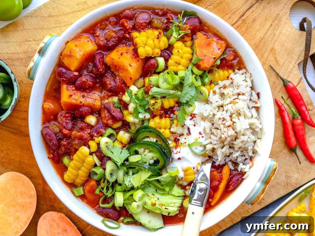 Hearty Sweet Potato Chili 3 sweet potato chili in a bowl topped with corn, lime, and cilantro