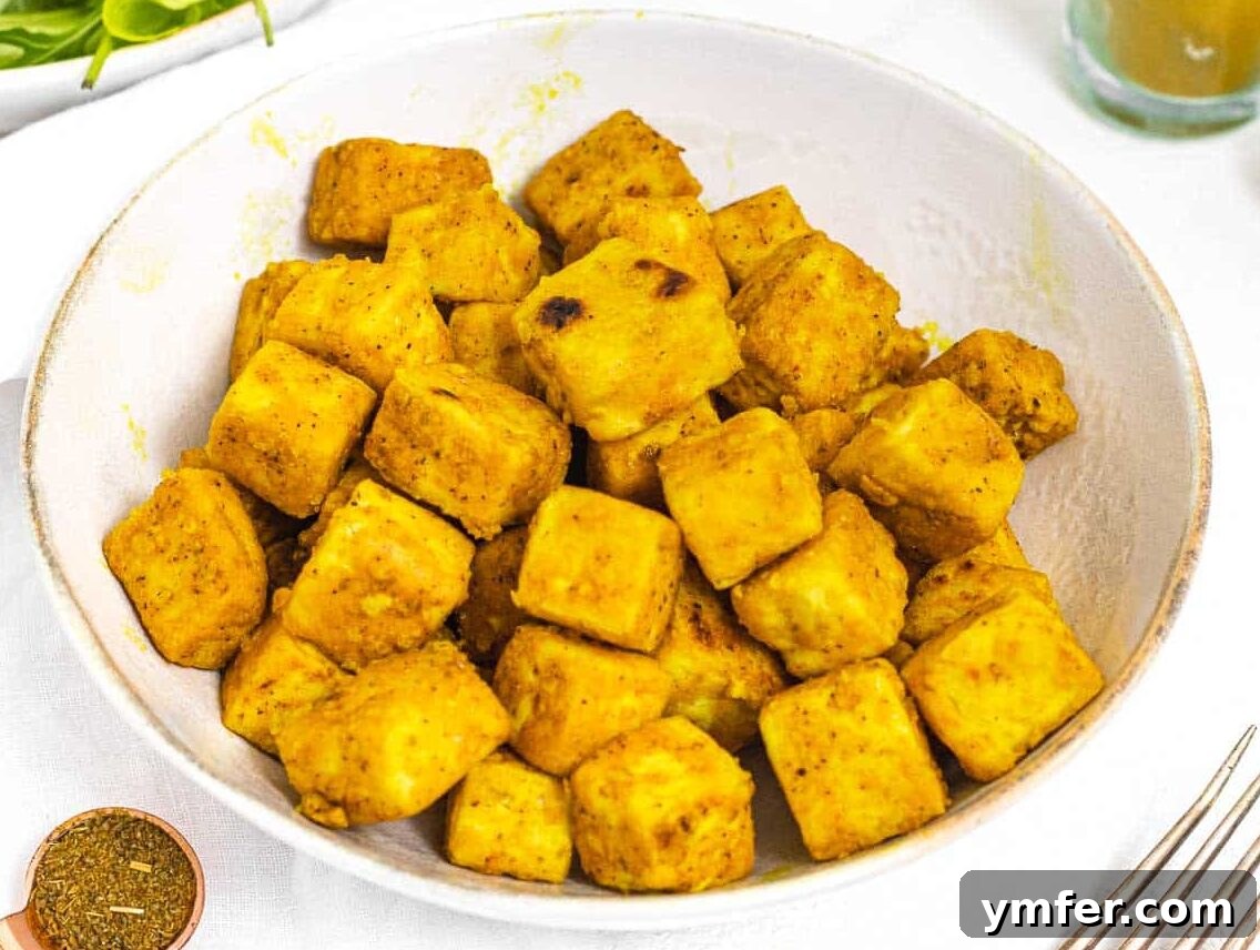 Curry tofu in a bowl, showcasing a protein-rich addition to a vegetarian meal.