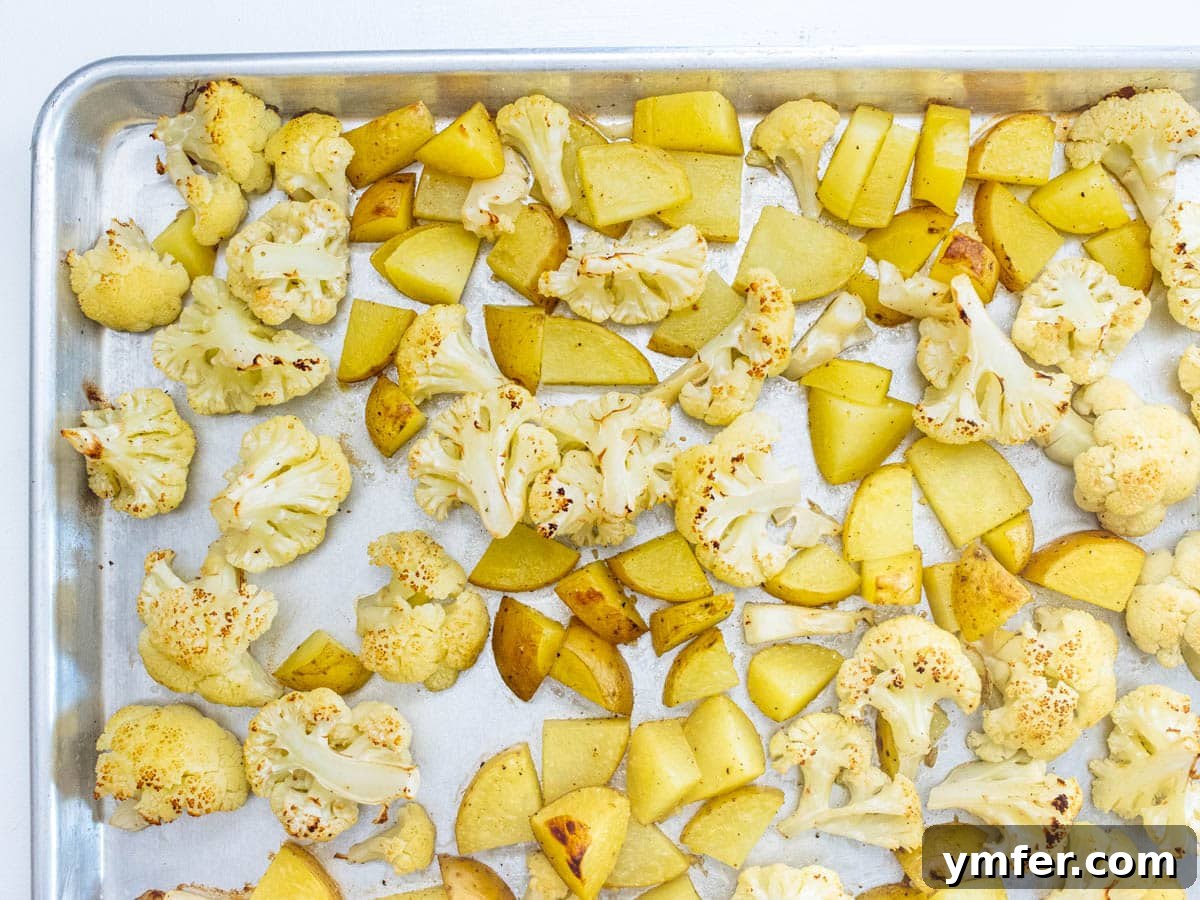 Roasted cauliflower and potatoes, golden and tender, fresh out of the oven.