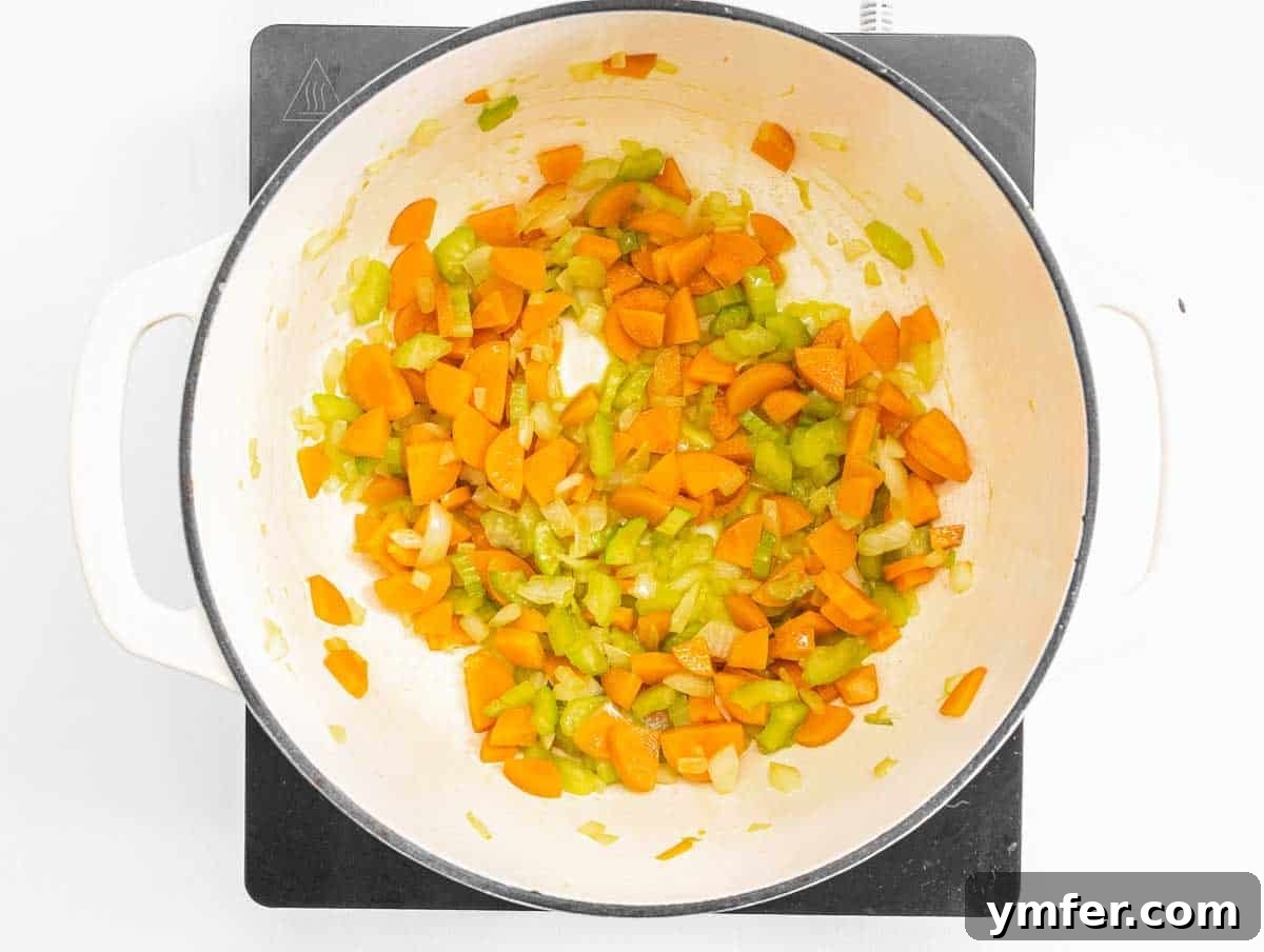 Golden Pea Goodness 6 Coarsely chopped carrots, celery, and onion sautéing in olive oil in a large pot, forming the aromatic flavor base for the pea soup.