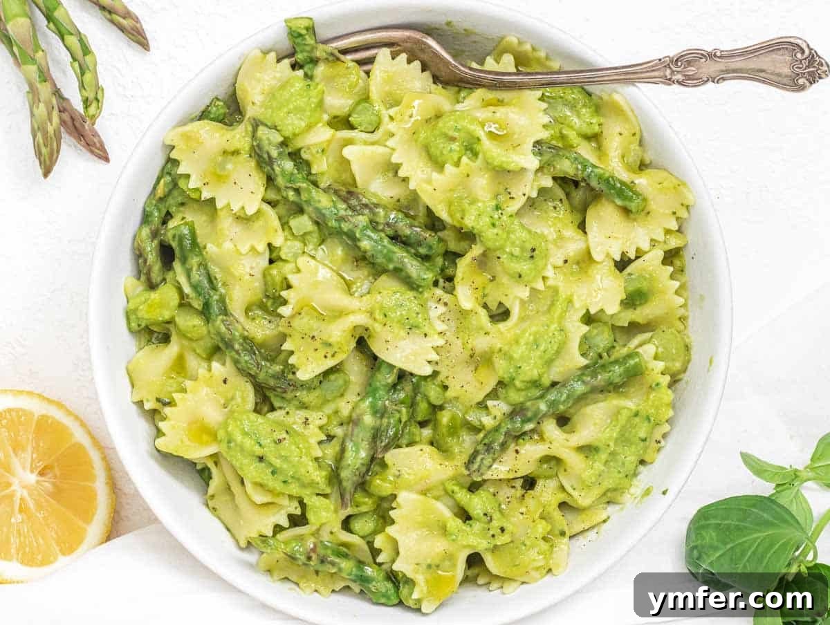 Effortless St Patricks Day Delights 15 Asparagus pasta with a fork and lemon wedges, a quick and green dish.