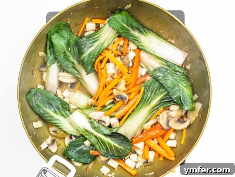 stir fried vegetables in a wok