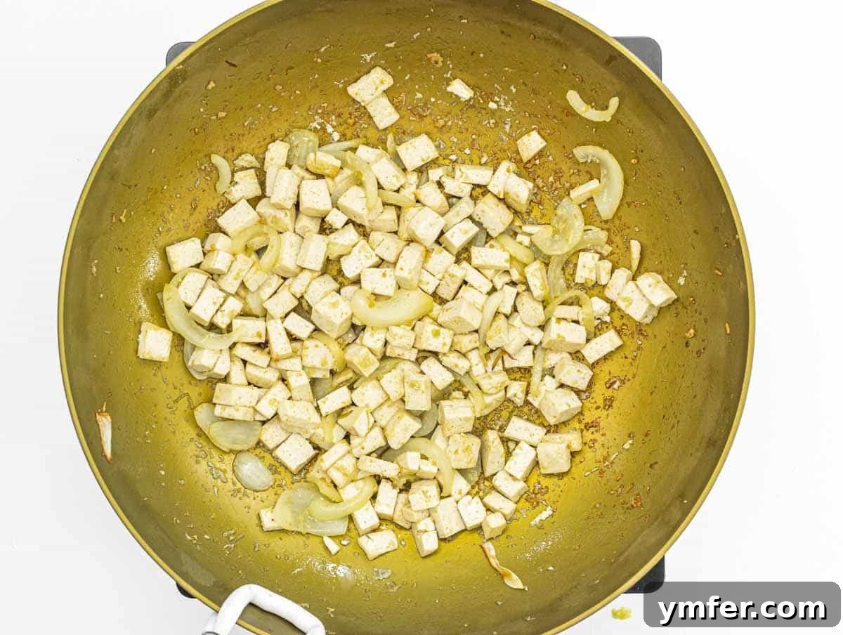 Sizzling Japanese Udon Stir-fry 10 tofu cubes and fried onion in a work
