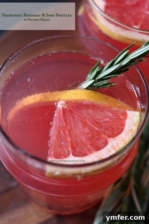 Zesty Herbaceous Grapefruit Sparkler 3 Close-up of Grapefruit Rosemary Sage Spritzer, showcasing its beautiful color and garnishes