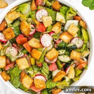 Fattoush salad in a serving bowl with fresh mint.
