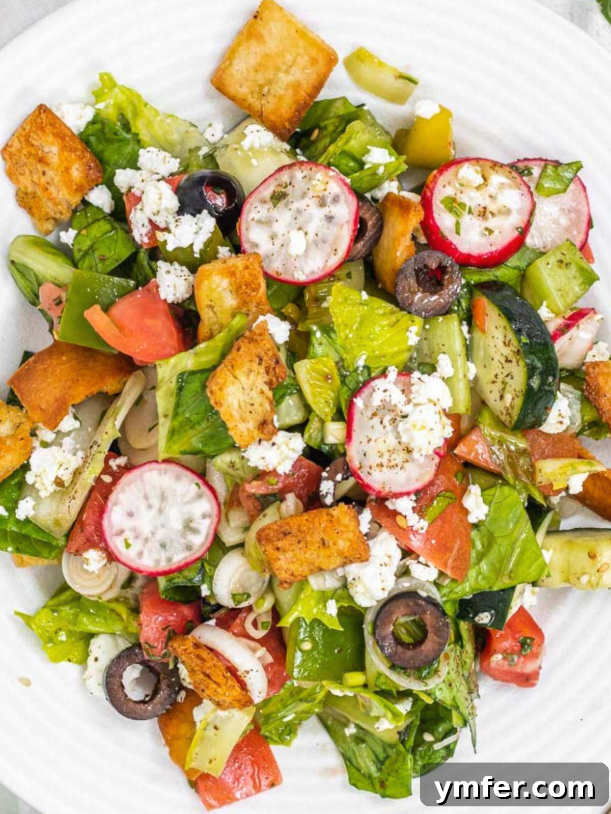 Fresh Fattoush 3 Fattoush with crumbled feta cheese and fresh mint leaves.