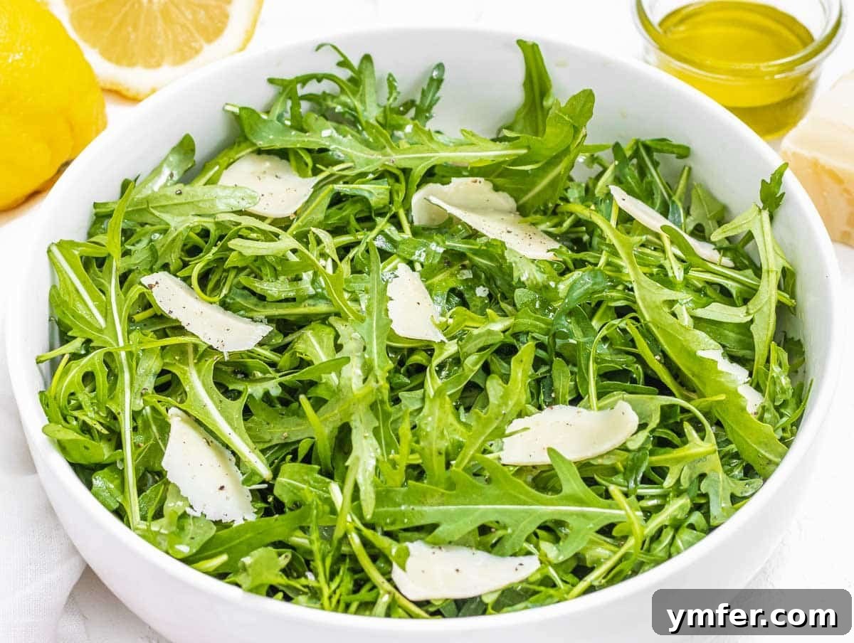 Rucola Rocket Greens with Citrus Vinaigrette 3 Arugula salad with shaved parmesan, showcasing fresh ingredients